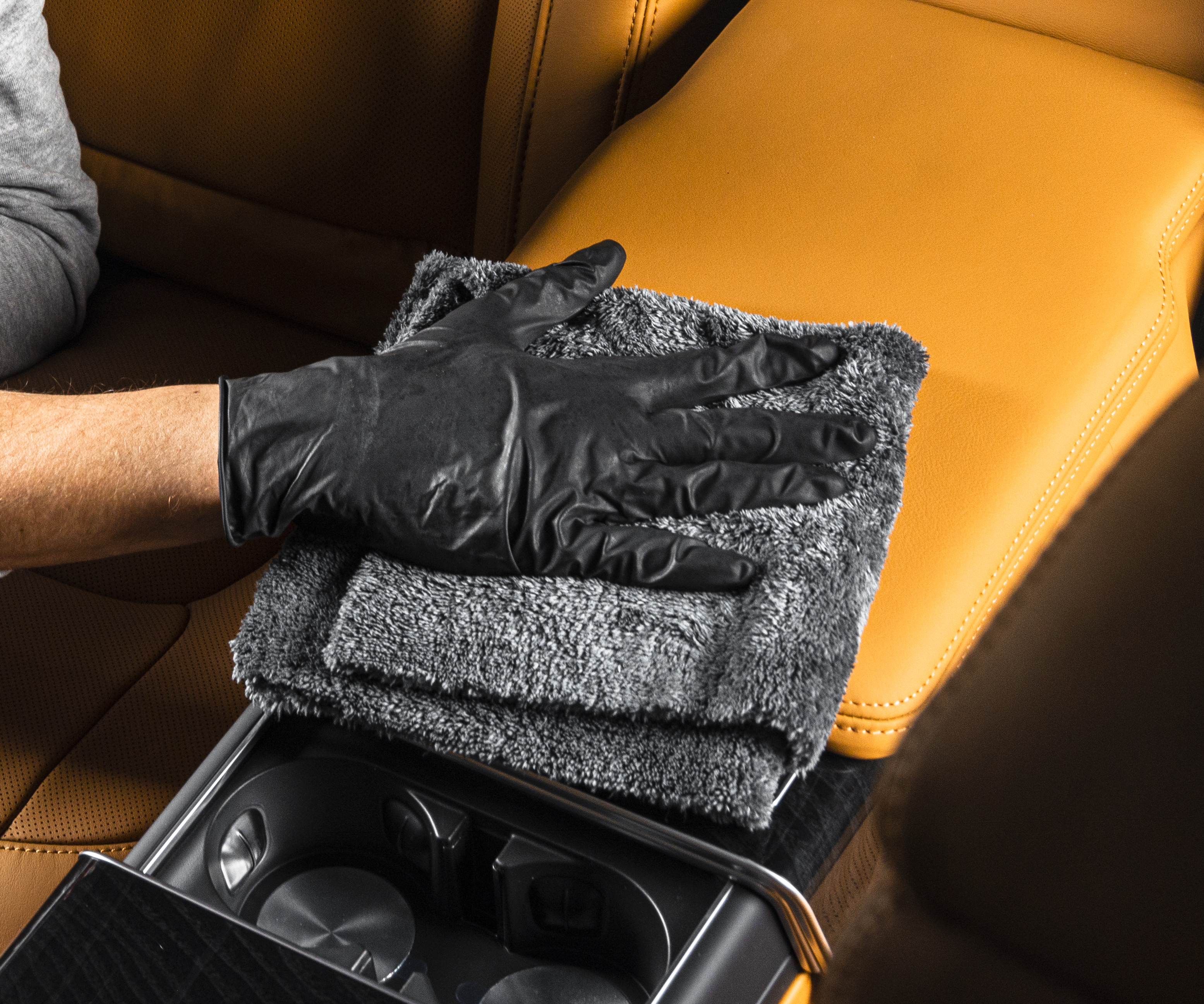 A man cleaning car interior with microfiber cloth.jpg