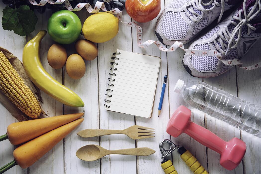 fitness-concept-with-exercise-equipment-on-white-wooden-backgrou