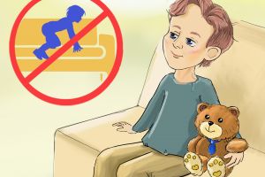 the boy is sitting on the sofa