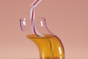 Curved glass with juice and a straw