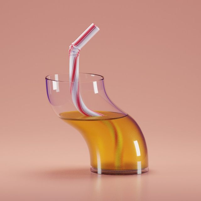 Curved glass with juice and a straw